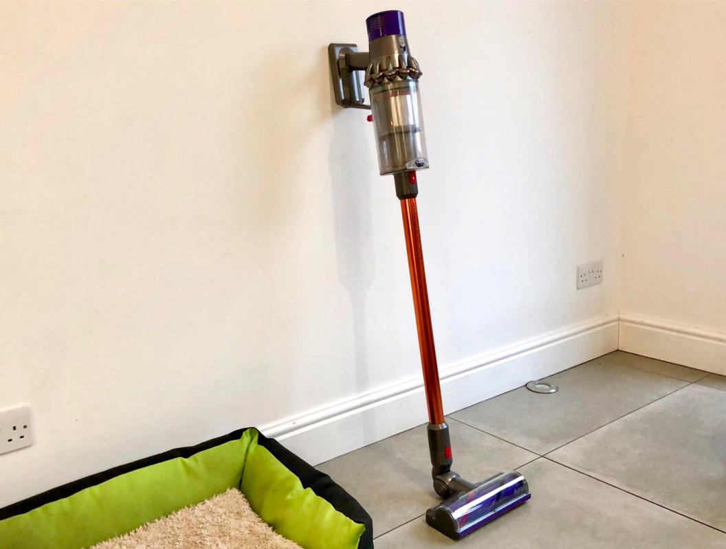 Dyson Cyclone V10 Absolute leaning on a wall